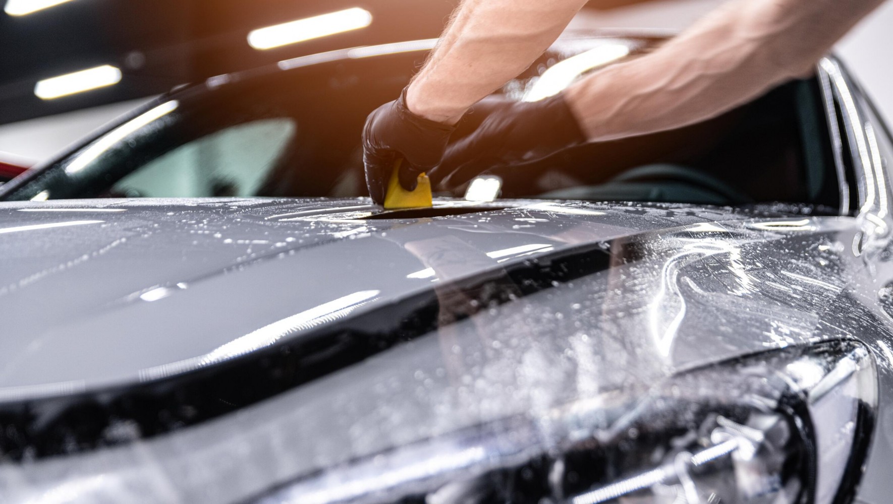 Paint protection film being applied to a car bonnet in Covestro’s press image.