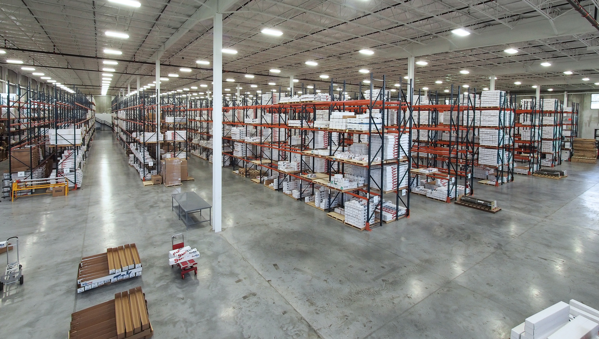 Warehouse racks holding SunTek-branded boxes in a photograph on SunTek’s website