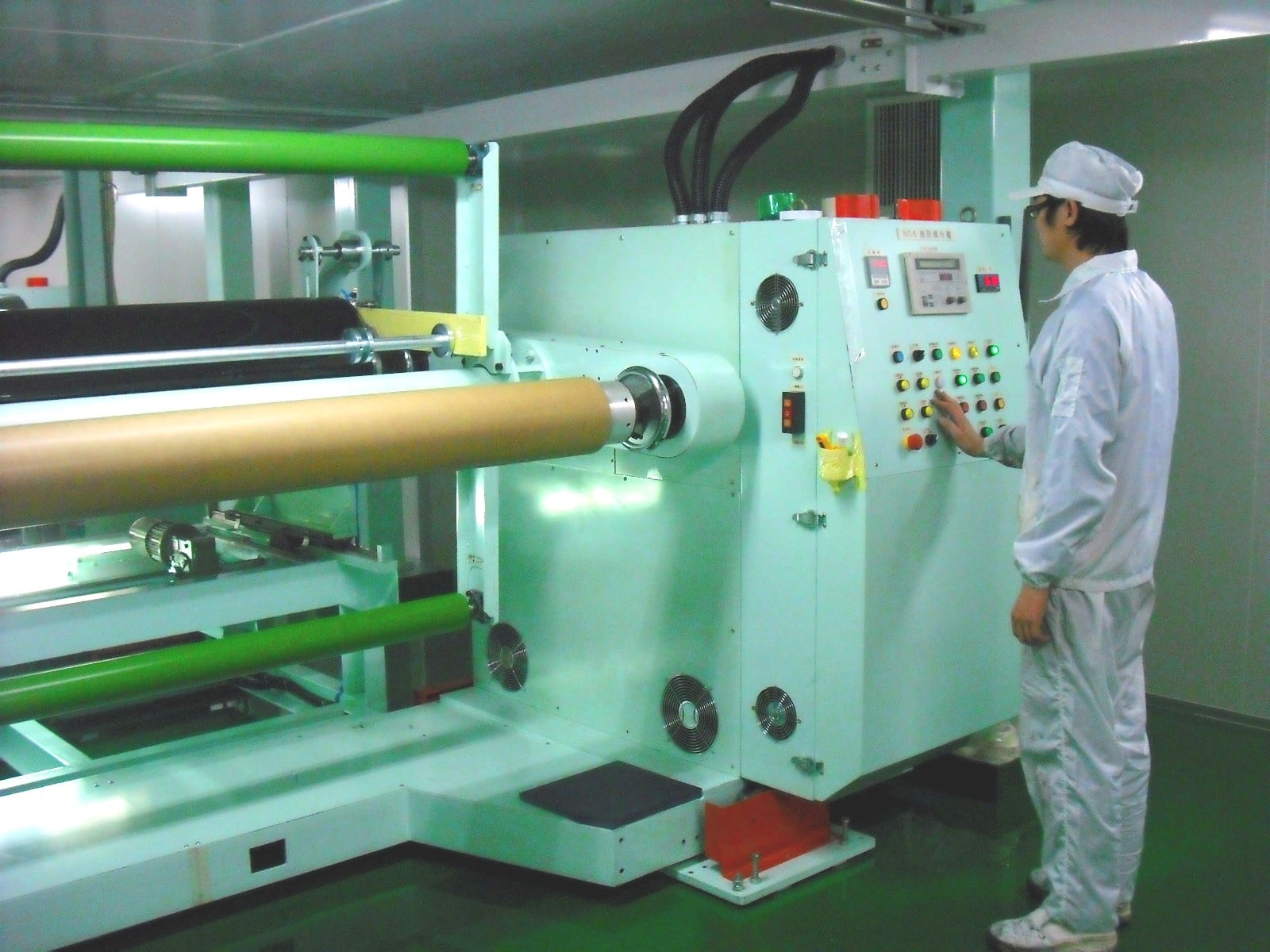 An operator beside film-processing equipment in Top Colour’s official photograph.